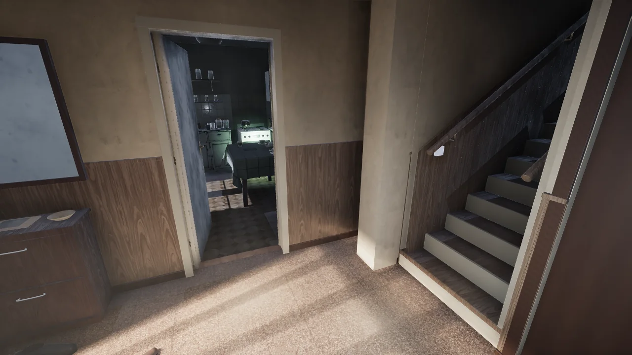 The hall with wood panelling, the stairs going up on the right and the lit kitchen through an open door.
