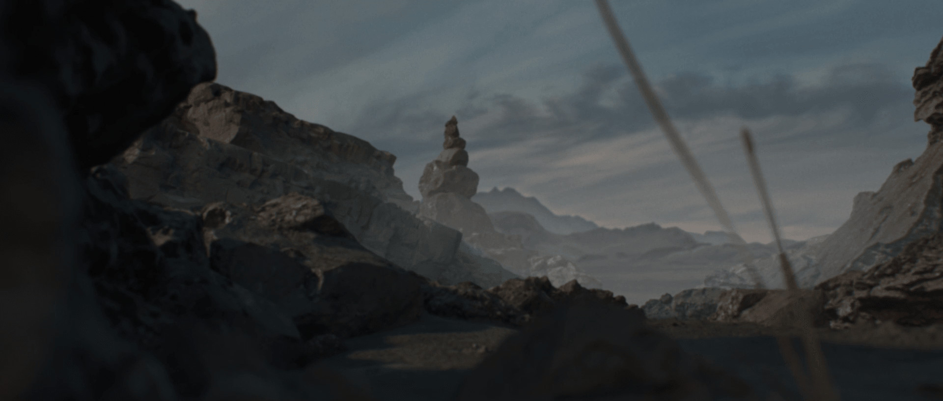The film&rsquo;s opening shot: rock formations and a stack of boulders above a hazy valley