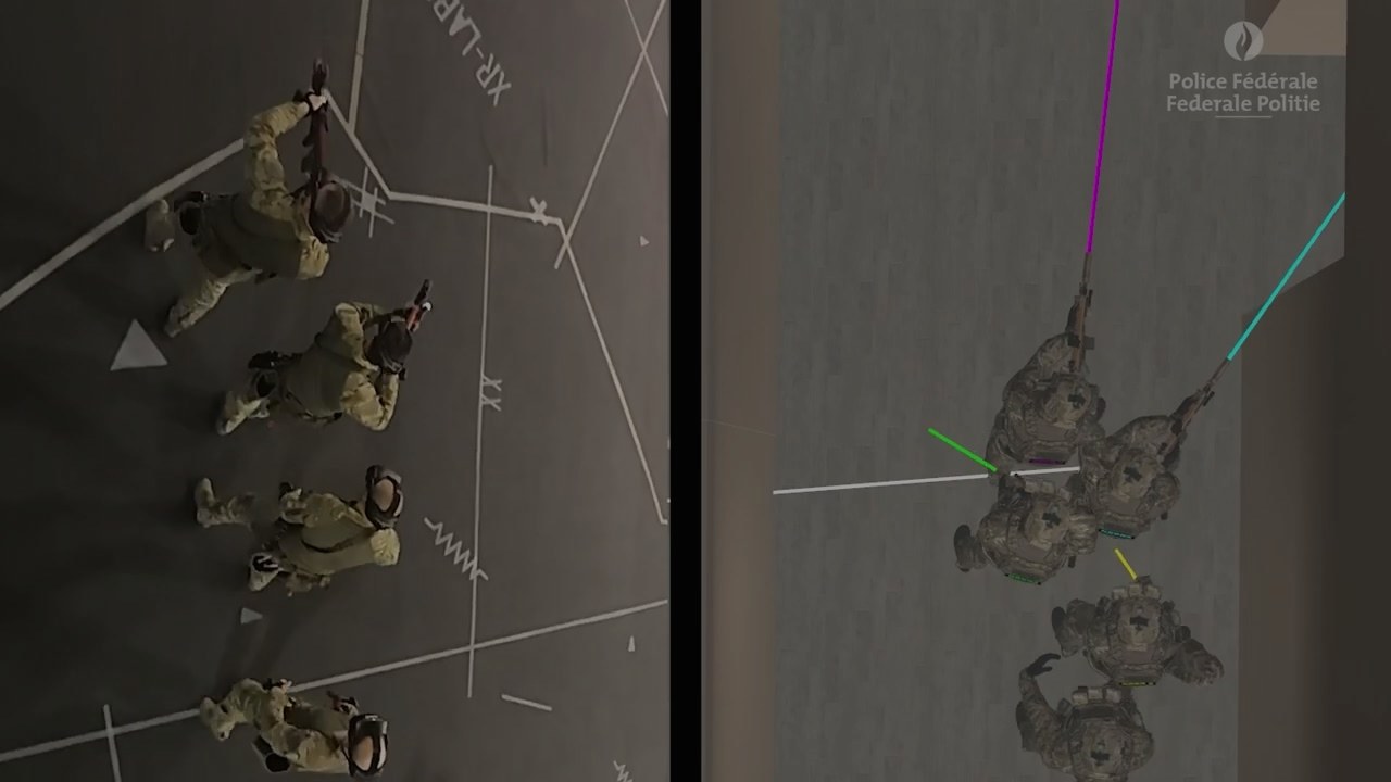 A split frame: four trainees walking across the marked hall floor seen from above, beside four avatars in a simulated room seen from the same angle, with coloured aim lines