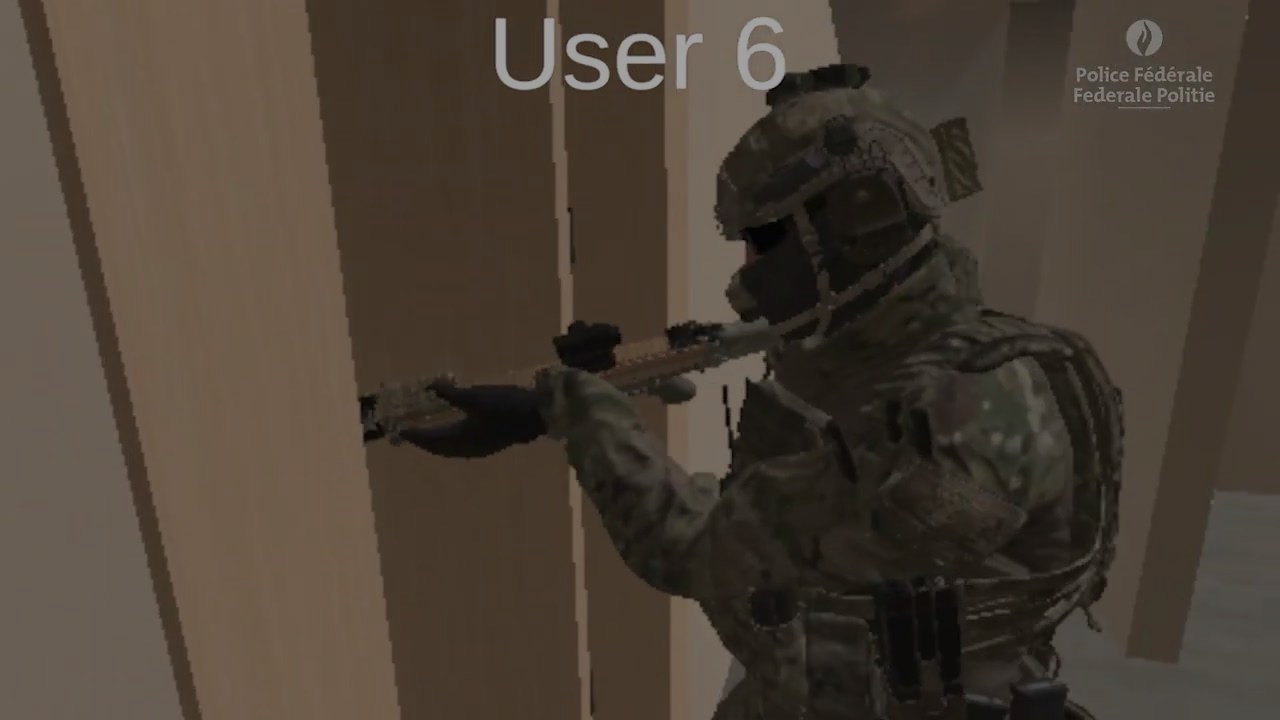 A first-person view in the simulation: a trainee avatar pressed against a wall that fills the left of the frame